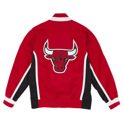 A red Chicago Bulls windbreaker jacket shown from the back, featuring a large embroidered Bulls logo on the center back with white and black side panels and white stripe accents.
