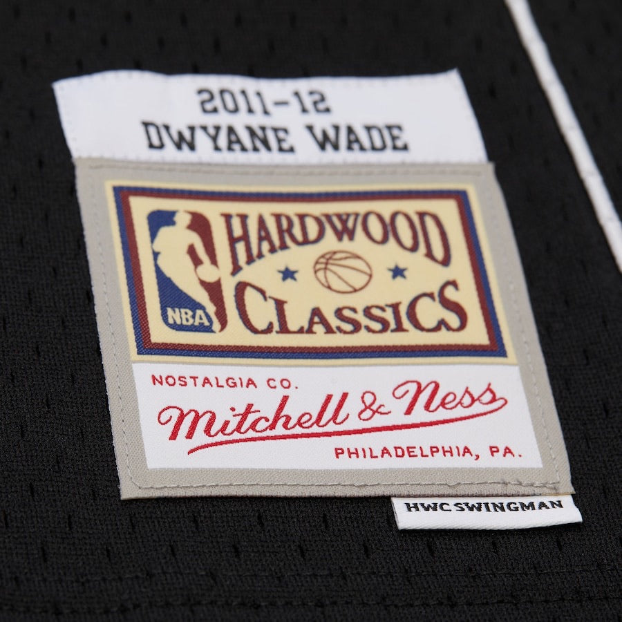 Label from a sports jersey featuring Dwyane Wade, Hardwood Classics, and Mitchell & Ness logos.