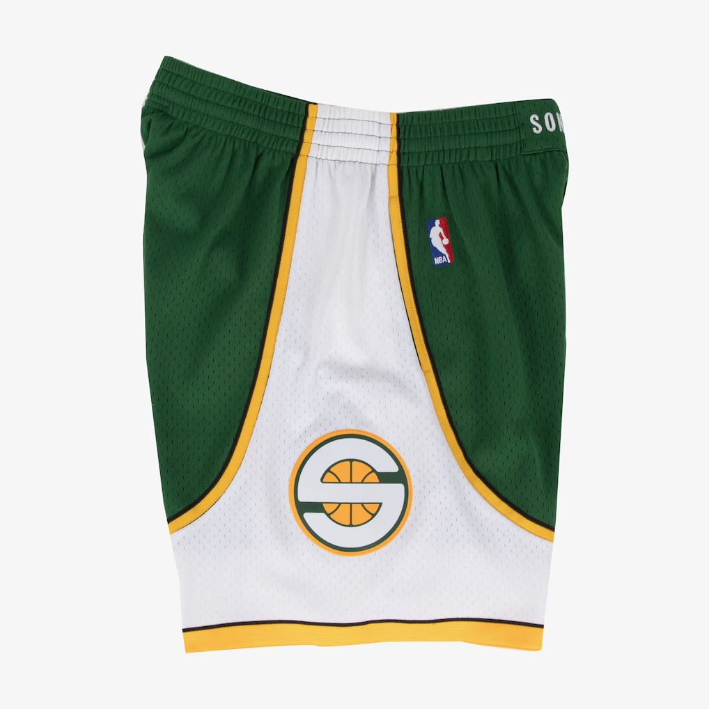 Green and white basketball shorts with a logo on a white background