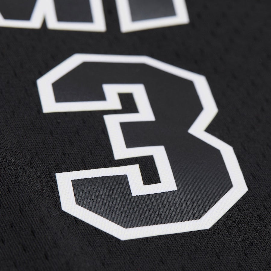 Close-up of a black sports jersey with the number '3' in white.
