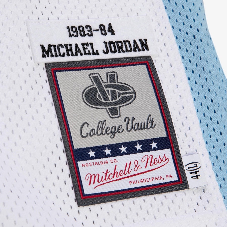 Close-up of a sports jersey label with 'Michael Jordan' and 'Mitchell & Ness' branding.